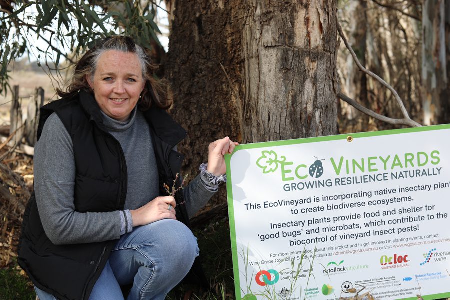 EcoVineyard participant smiling while holding her EcoVineyards signage